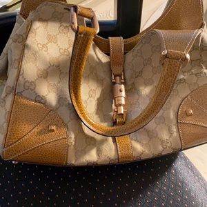 Gucci bag tan with gold/bronze metal, combination of cloth and leather.